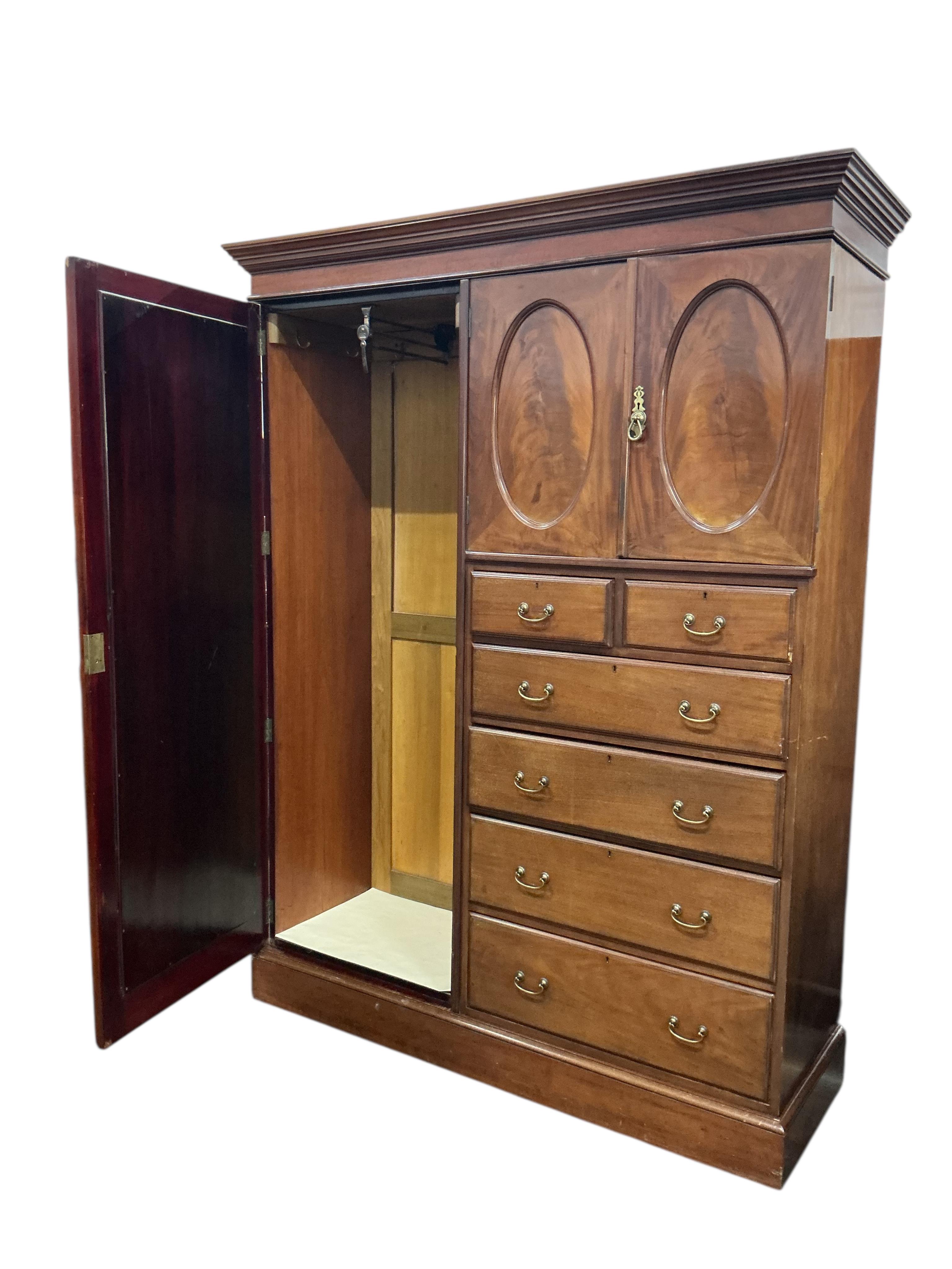 An early 20th century mahogany mirrored compactum wardrobe, width 154cm, depth 50cm, height 208cm